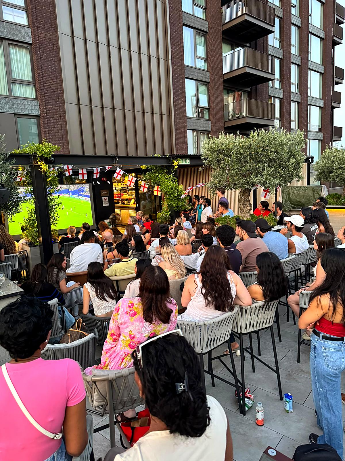 Neighbours gathering to watch the football together at Embassy Gardens